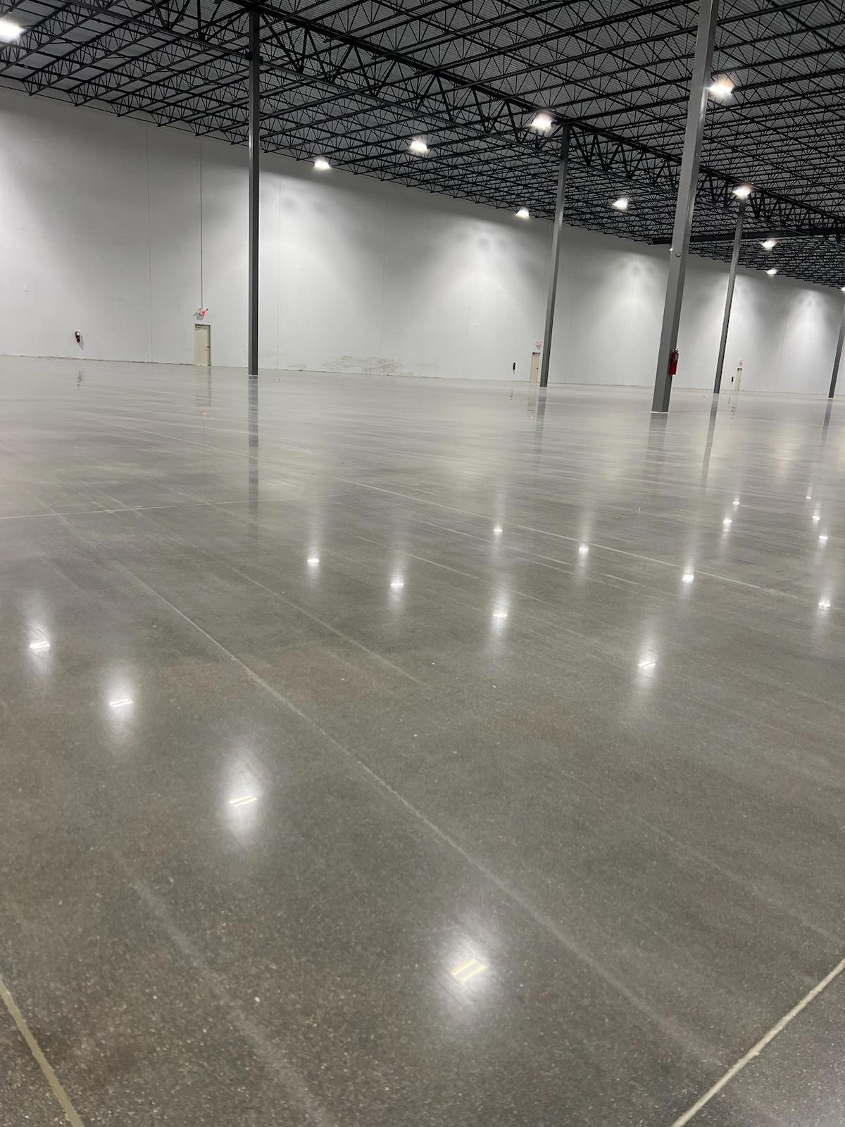 Finished polished concrete warehouse interior in Mount Juliet, Tennessee, showing light reflectivity