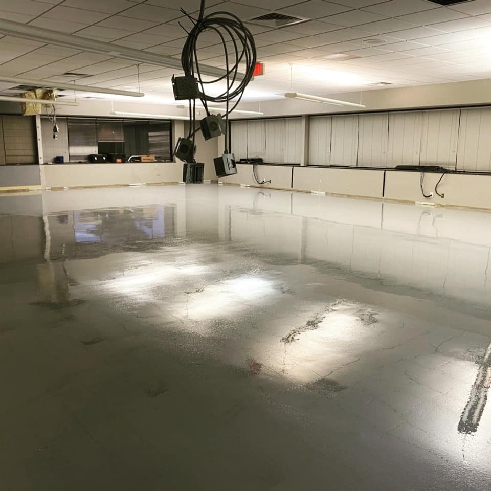 Battery manufacturing facility finished epoxy coating with integral cove base