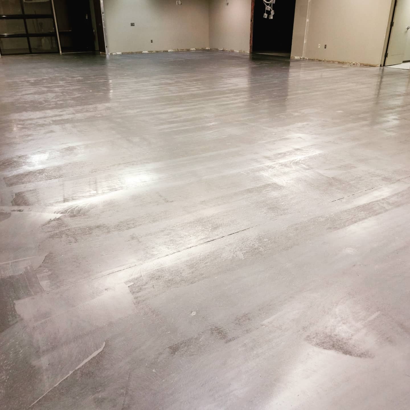 Pre-coating surface condition, stained and worn concrete at a Royal Oak battery facility
