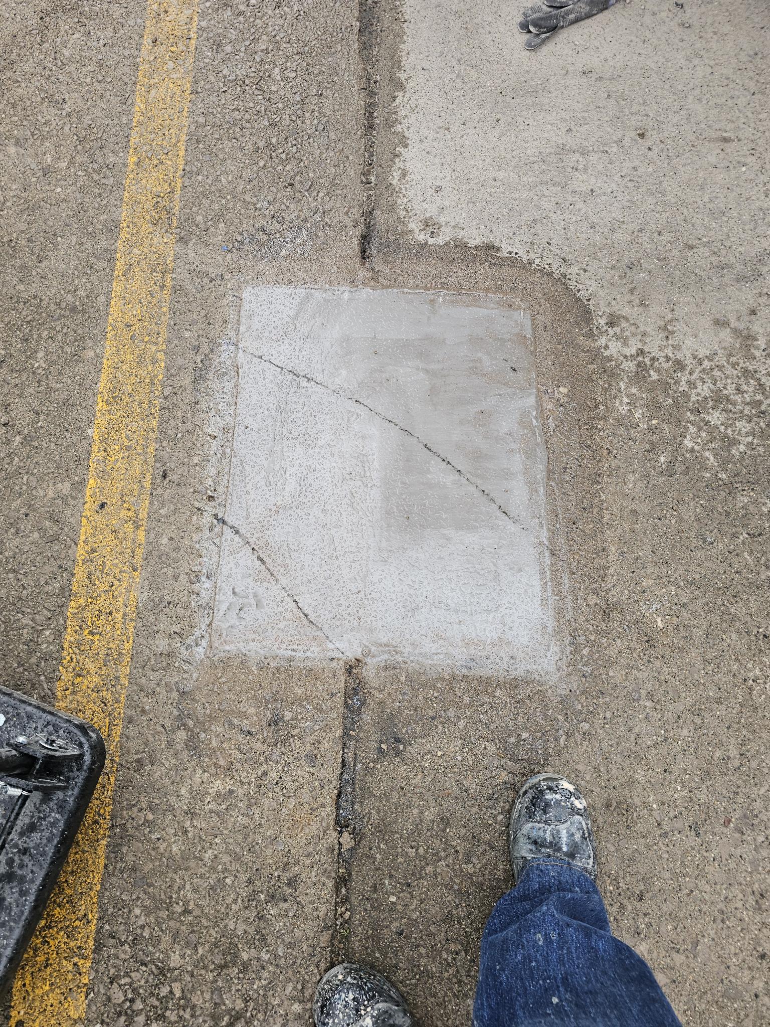 Completed concrete patch, dolly pad restored and level