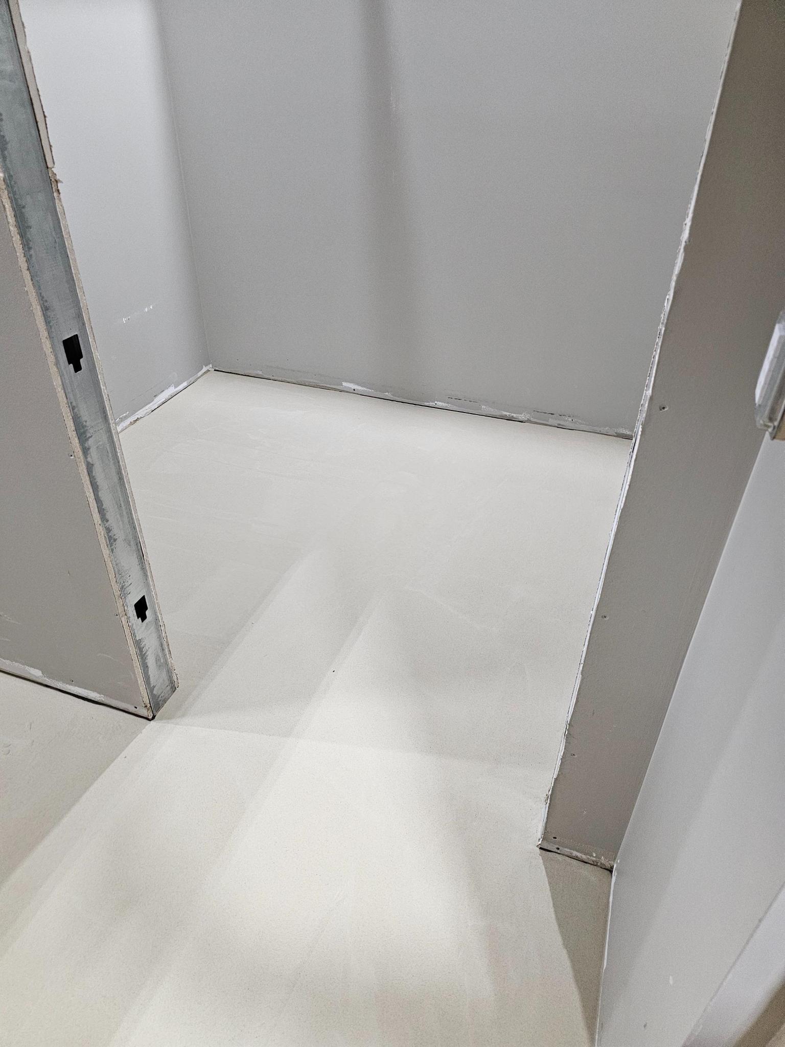 Integral cove base installation at the wall transition