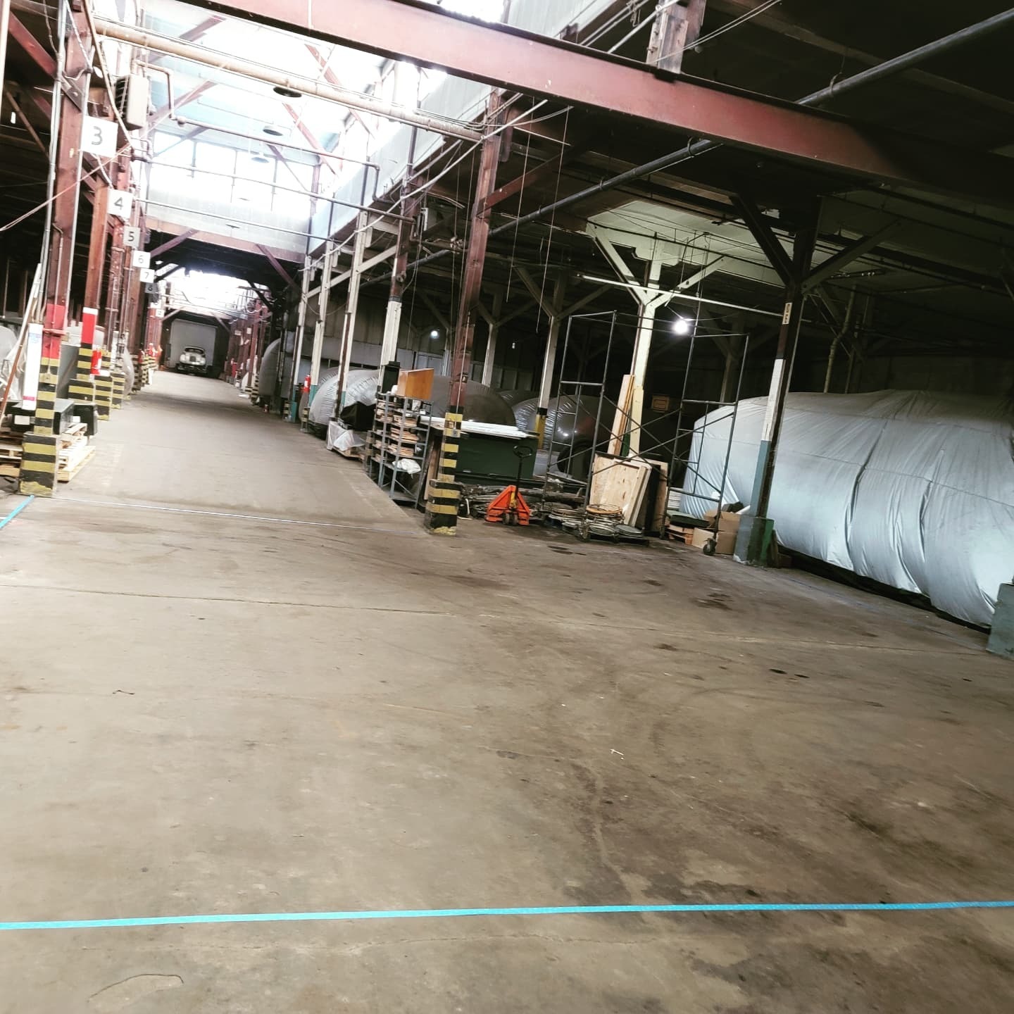 Original warehouse floor showing wear and damage before coating