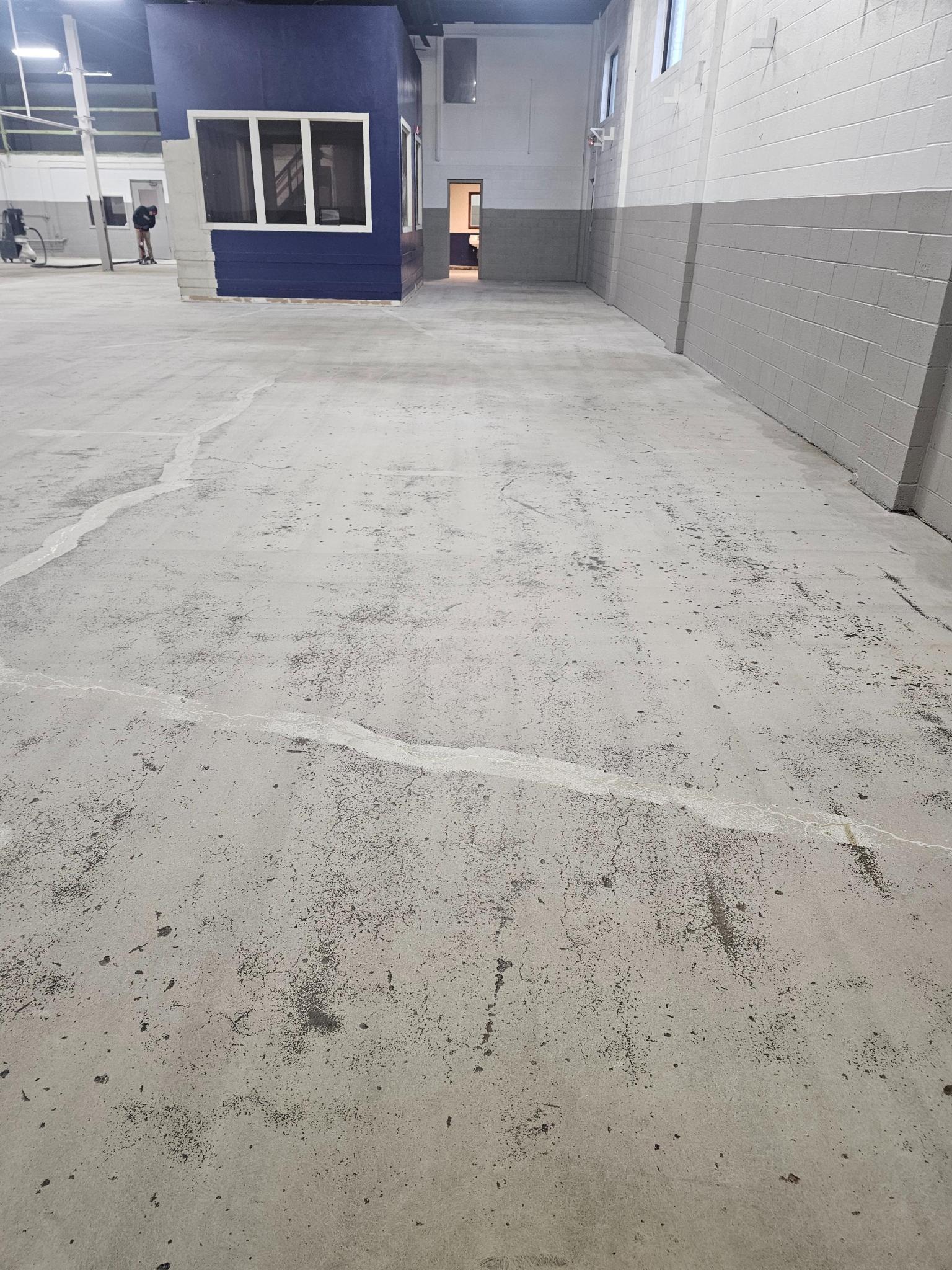 Worn machine shop concrete floor in Livonia before coating