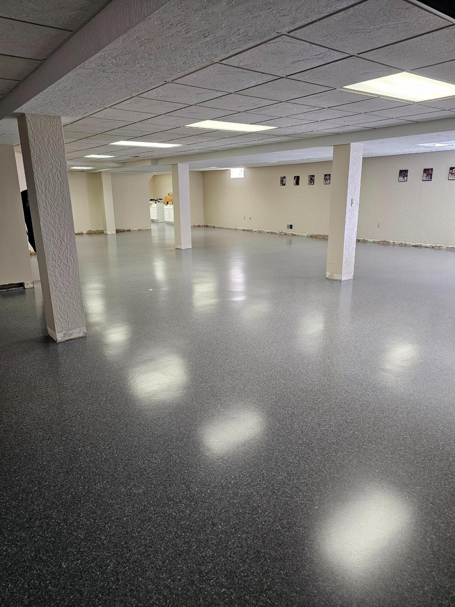 Open basement layout with full epoxy floor coating
